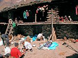 Manaslu 06 02 Lihi Lunch In Local House Yard We stopped for lunch in the back of a local house, with wood stacked high, clothes drying, barley let out to dry, and children looking on.